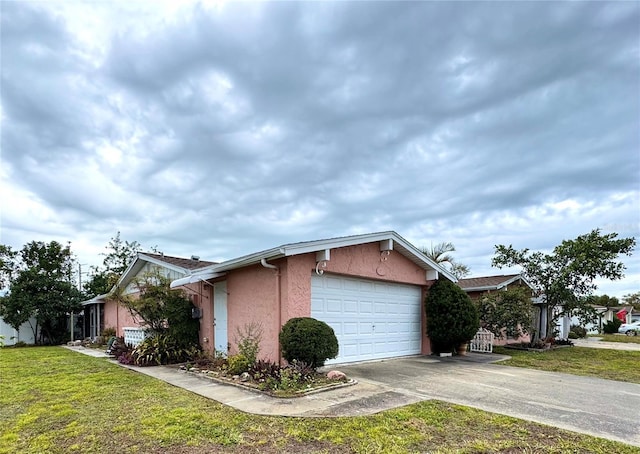 view of side of property featuring a garage and a lawn