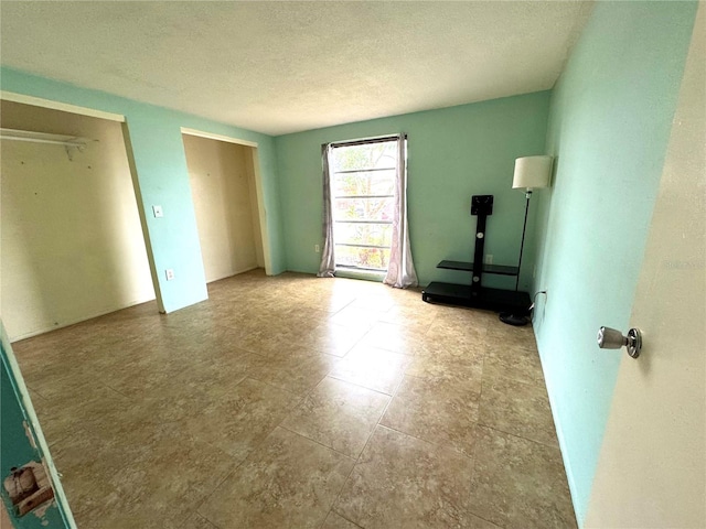 unfurnished bedroom featuring a textured ceiling