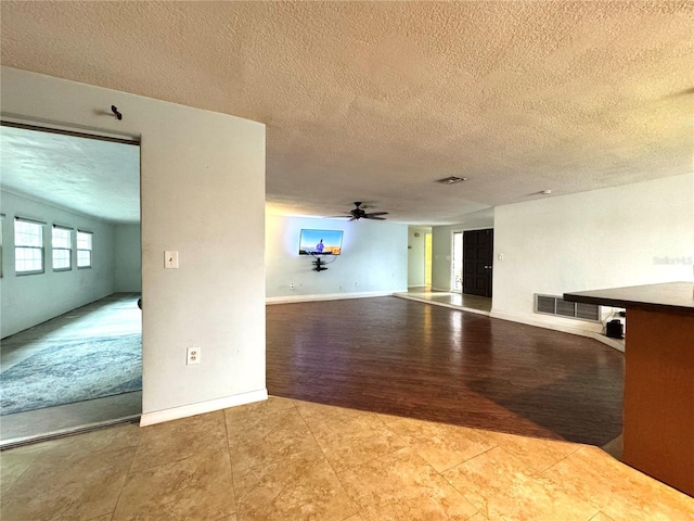 spare room with ceiling fan and a textured ceiling