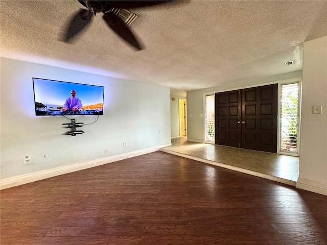 entrance foyer featuring ceiling fan, hardwood / wood-style floors, and a textured ceiling