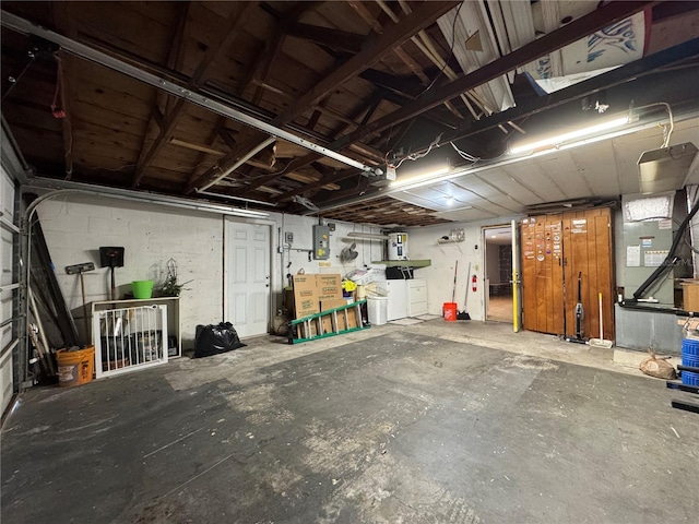 garage featuring separate washer and dryer and electric panel