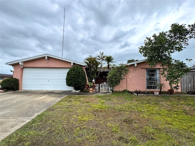 view of front of home with a front yard and a garage