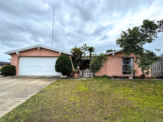 single story home featuring a garage and a front yard