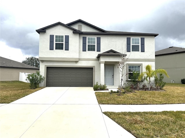 view of property featuring a front yard and a garage