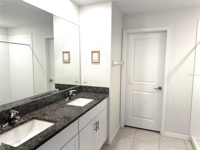 bathroom featuring vanity, a shower, and tile patterned floors