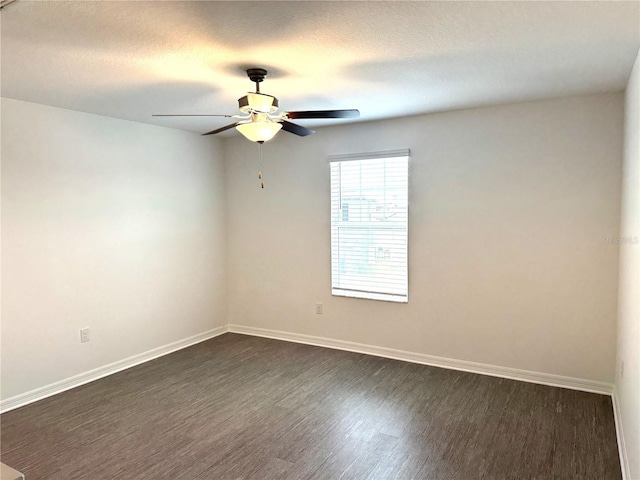 unfurnished room with a textured ceiling, dark wood-type flooring, and ceiling fan