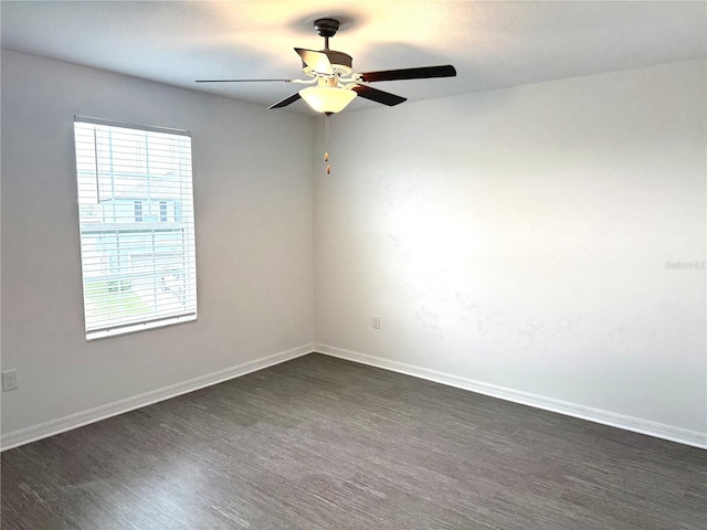 spare room featuring ceiling fan and dark hardwood / wood-style flooring