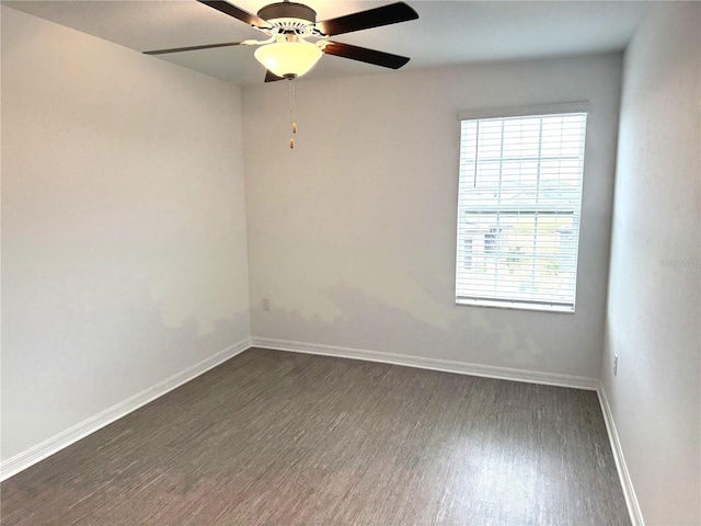 spare room with ceiling fan and dark hardwood / wood-style flooring