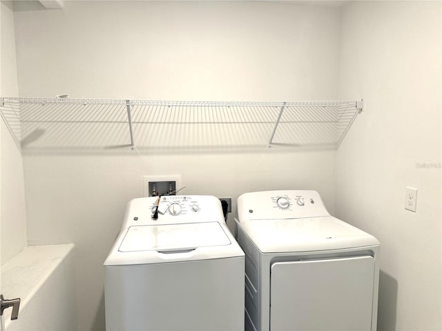 laundry room with washing machine and clothes dryer