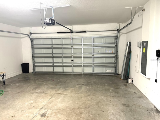 garage with a garage door opener and electric panel