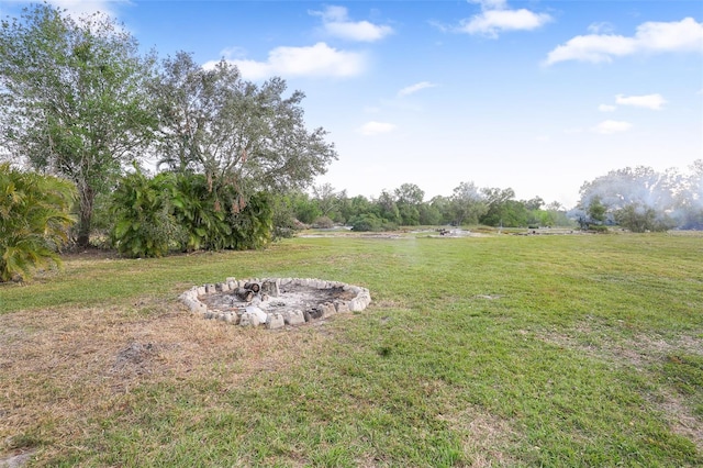 view of yard featuring a rural view and a fire pit