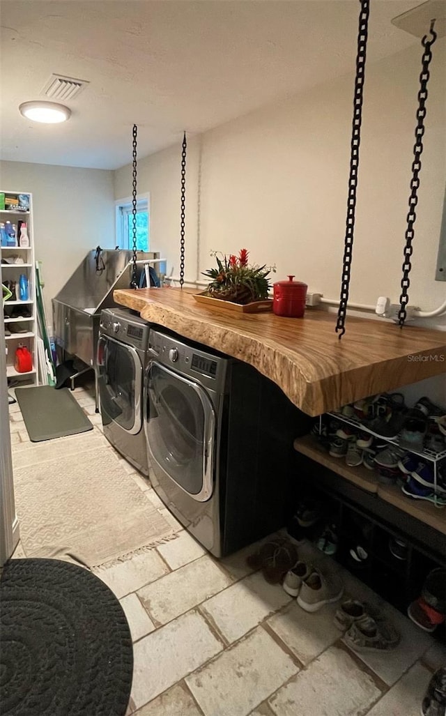 laundry area with washing machine and clothes dryer