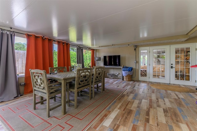 dining space with hardwood / wood-style floors and french doors