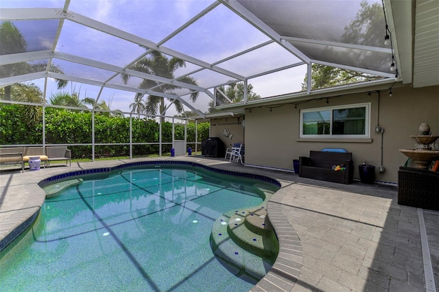 view of pool featuring a lanai and a patio area