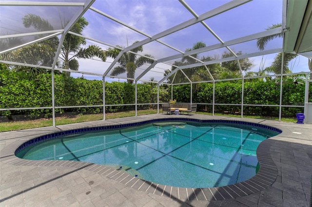 view of swimming pool with glass enclosure and a patio area