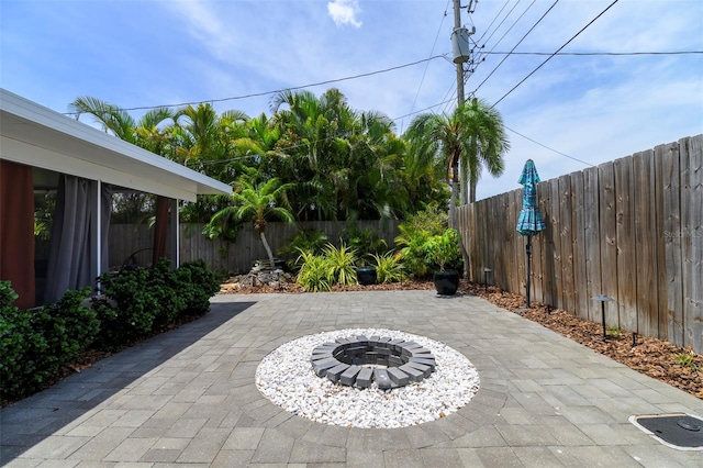 view of patio / terrace featuring an outdoor fire pit