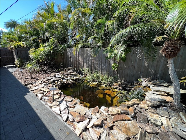 view of yard with a garden pond