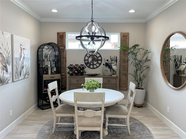 dining area with light wood-type flooring, ornamental molding, and a notable chandelier