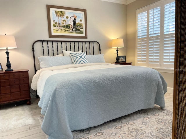 bedroom featuring light hardwood / wood-style flooring and ornamental molding