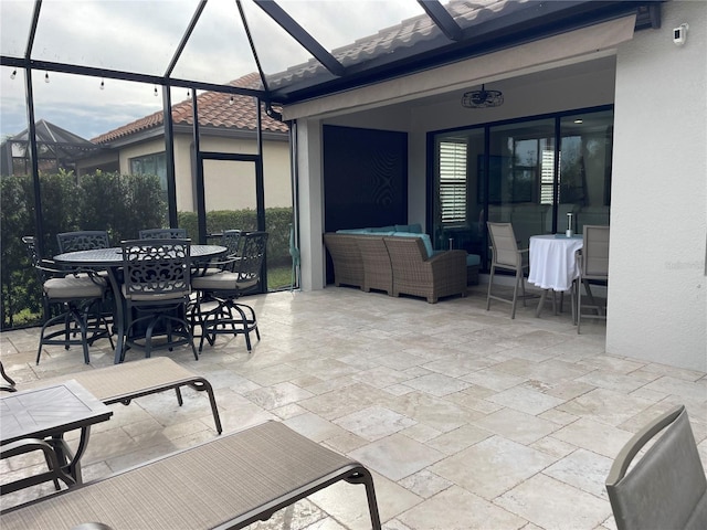 view of patio with glass enclosure and an outdoor living space