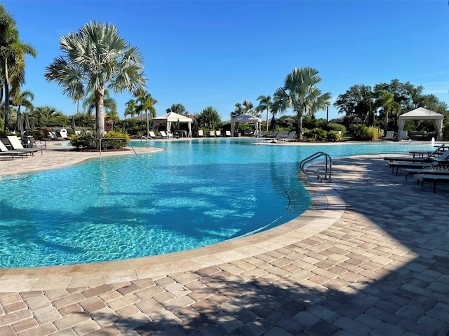 view of swimming pool featuring a gazebo and a patio