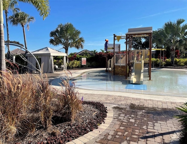 view of swimming pool with a playground