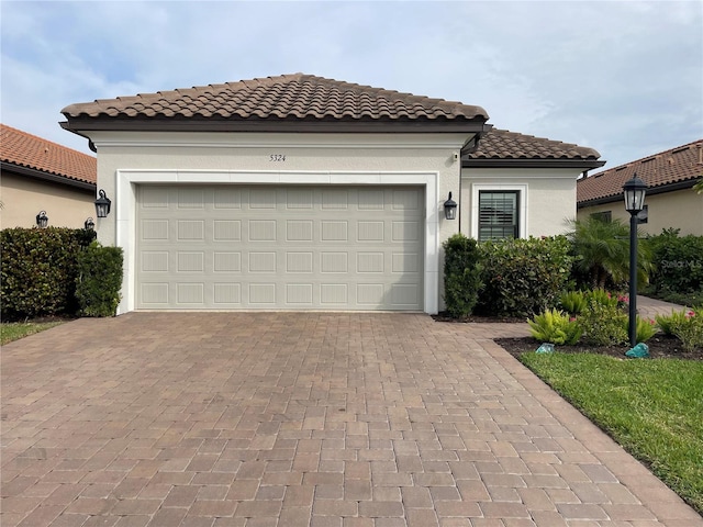 mediterranean / spanish house with a garage