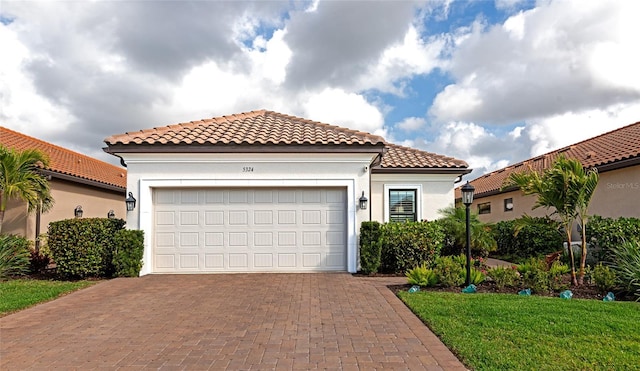 mediterranean / spanish home featuring a garage