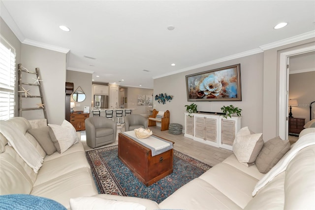 living room with ornamental molding and light hardwood / wood-style floors