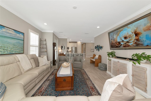 living room featuring ornamental molding and light hardwood / wood-style floors