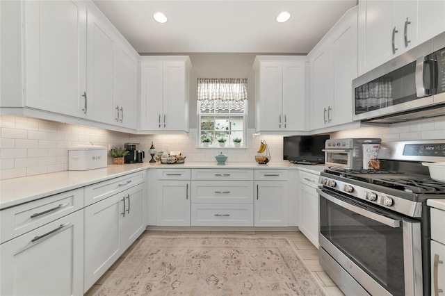 kitchen with white cabinetry, tasteful backsplash, and appliances with stainless steel finishes