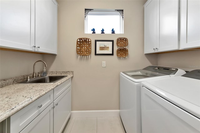 clothes washing area featuring sink, light tile patterned floors, cabinets, and independent washer and dryer