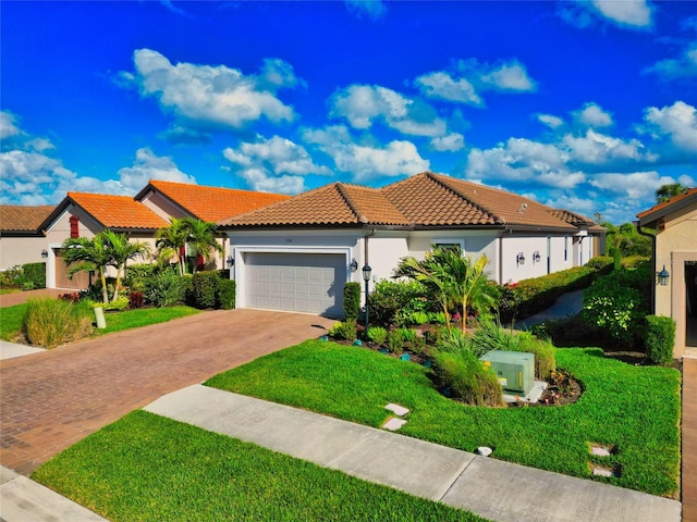 mediterranean / spanish-style house with a garage and a front yard