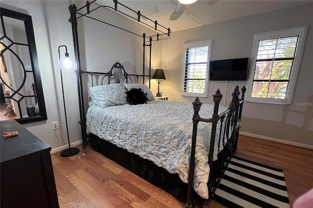 bedroom featuring hardwood / wood-style flooring and ceiling fan