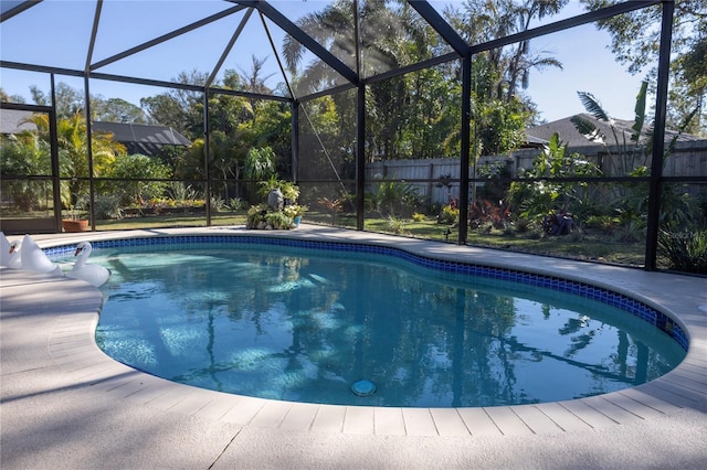 view of pool with glass enclosure