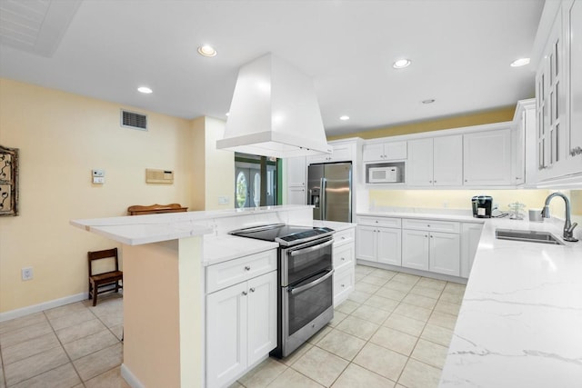 kitchen with sink, white cabinetry, island exhaust hood, stainless steel appliances, and light stone countertops