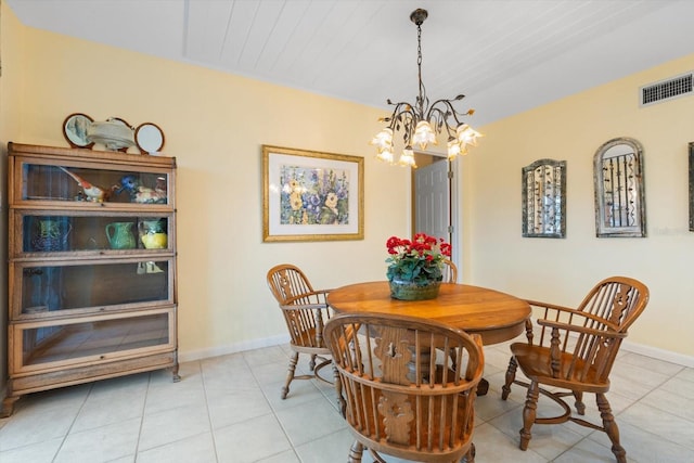 tiled dining room featuring a notable chandelier