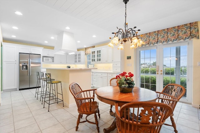 dining room with light tile patterned flooring, a notable chandelier, and french doors