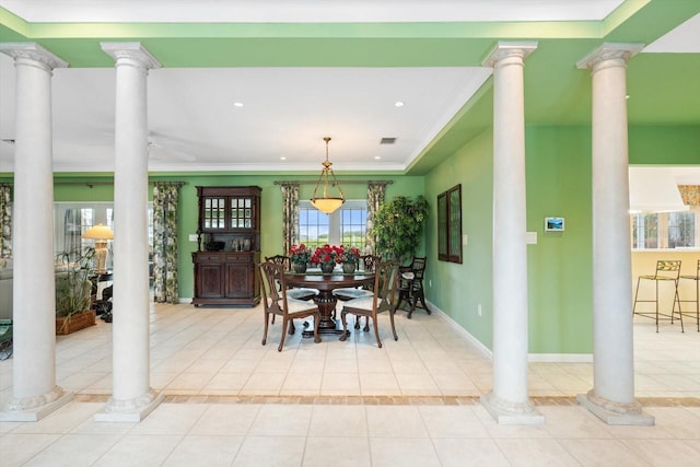 tiled dining space featuring ornamental molding and decorative columns