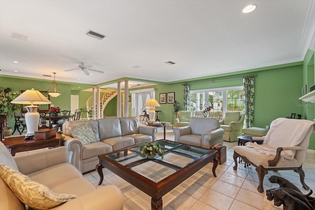 tiled living room with ornamental molding and ceiling fan