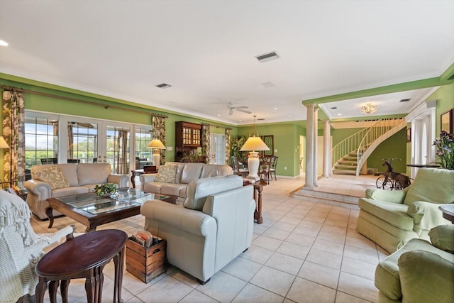 tiled living room with french doors, ceiling fan, ornamental molding, and decorative columns