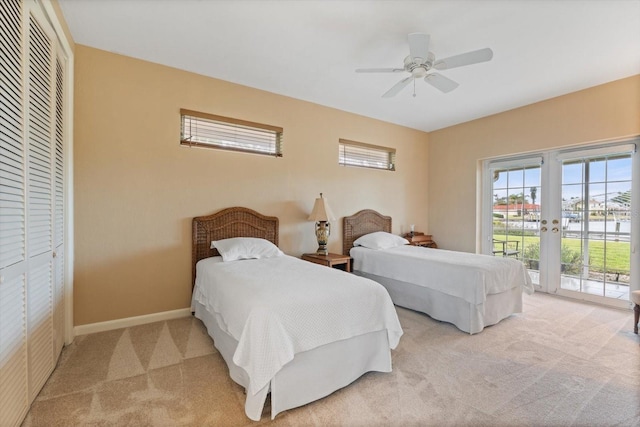 carpeted bedroom featuring a closet, access to outside, ceiling fan, and french doors