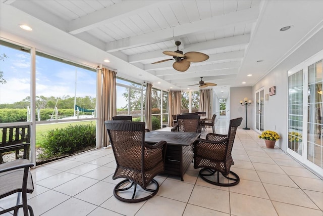 sunroom featuring a healthy amount of sunlight and beamed ceiling