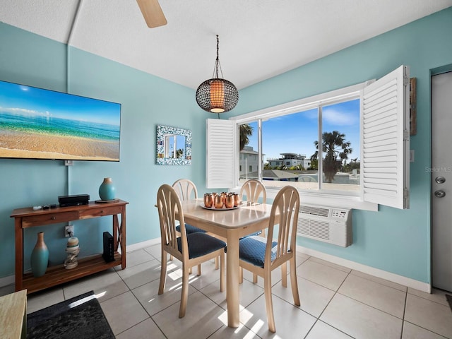 dining space featuring ceiling fan, light tile patterned floors, and a textured ceiling