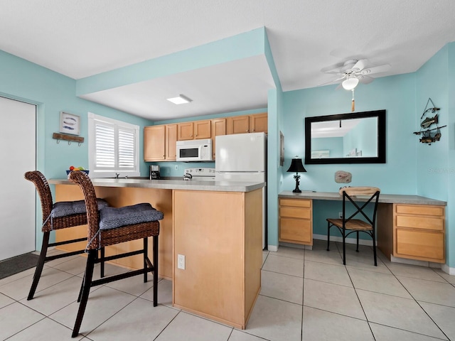 kitchen featuring ceiling fan, white appliances, light tile patterned floors, and light brown cabinetry