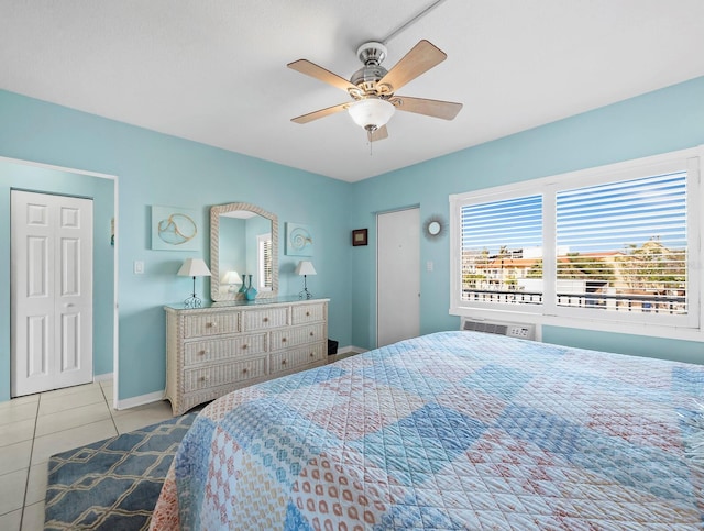 tiled bedroom featuring ceiling fan and a closet