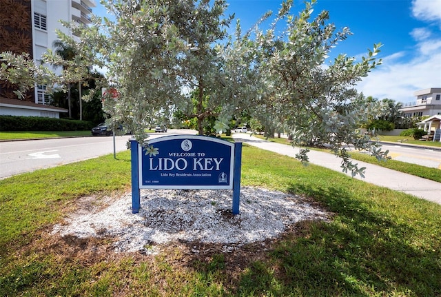 community sign featuring a lawn