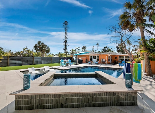 view of pool featuring an in ground hot tub and a patio