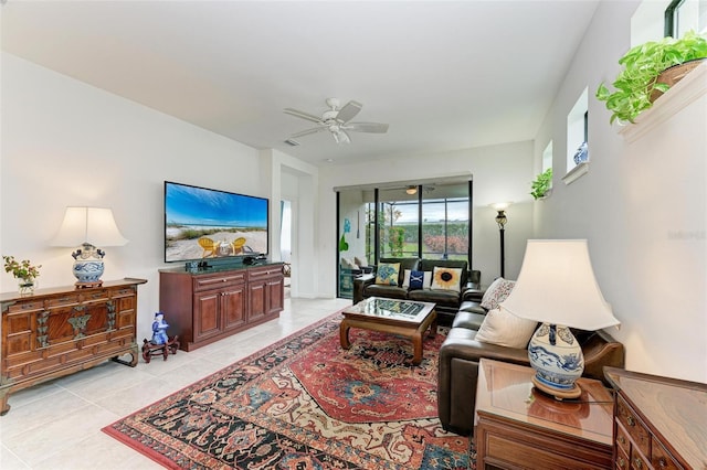 tiled living room with ceiling fan