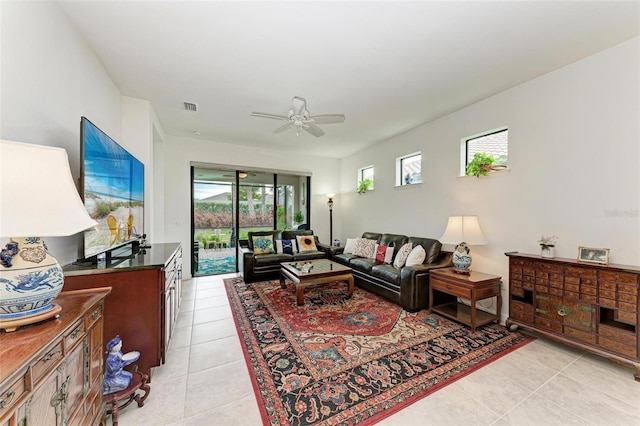 living room with ceiling fan and light tile patterned floors